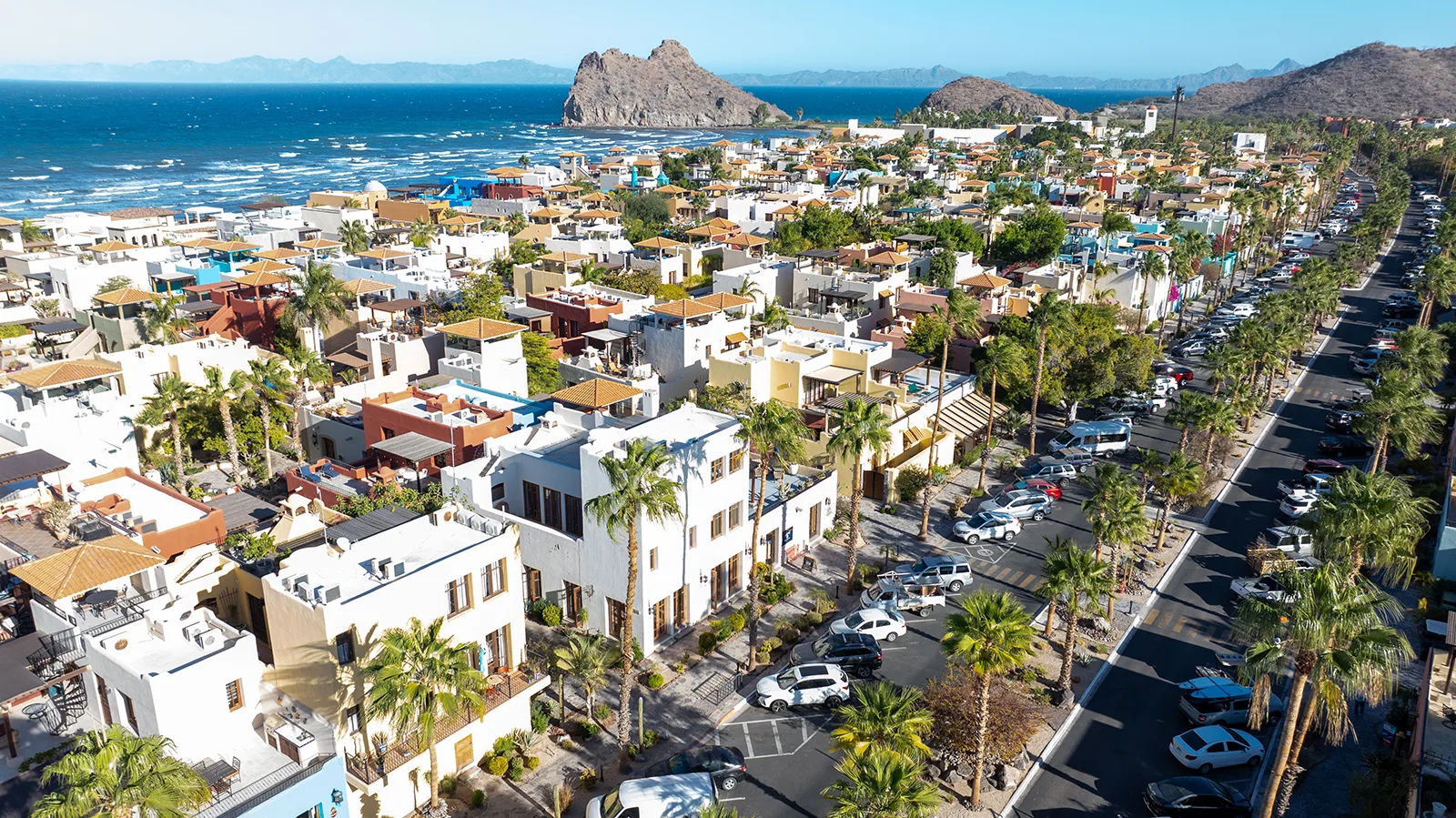 An aerial view of the Commercial Center of Loreto Bay with the Sea of Cortez and the Sierra de la Giganta mountains in the distance.