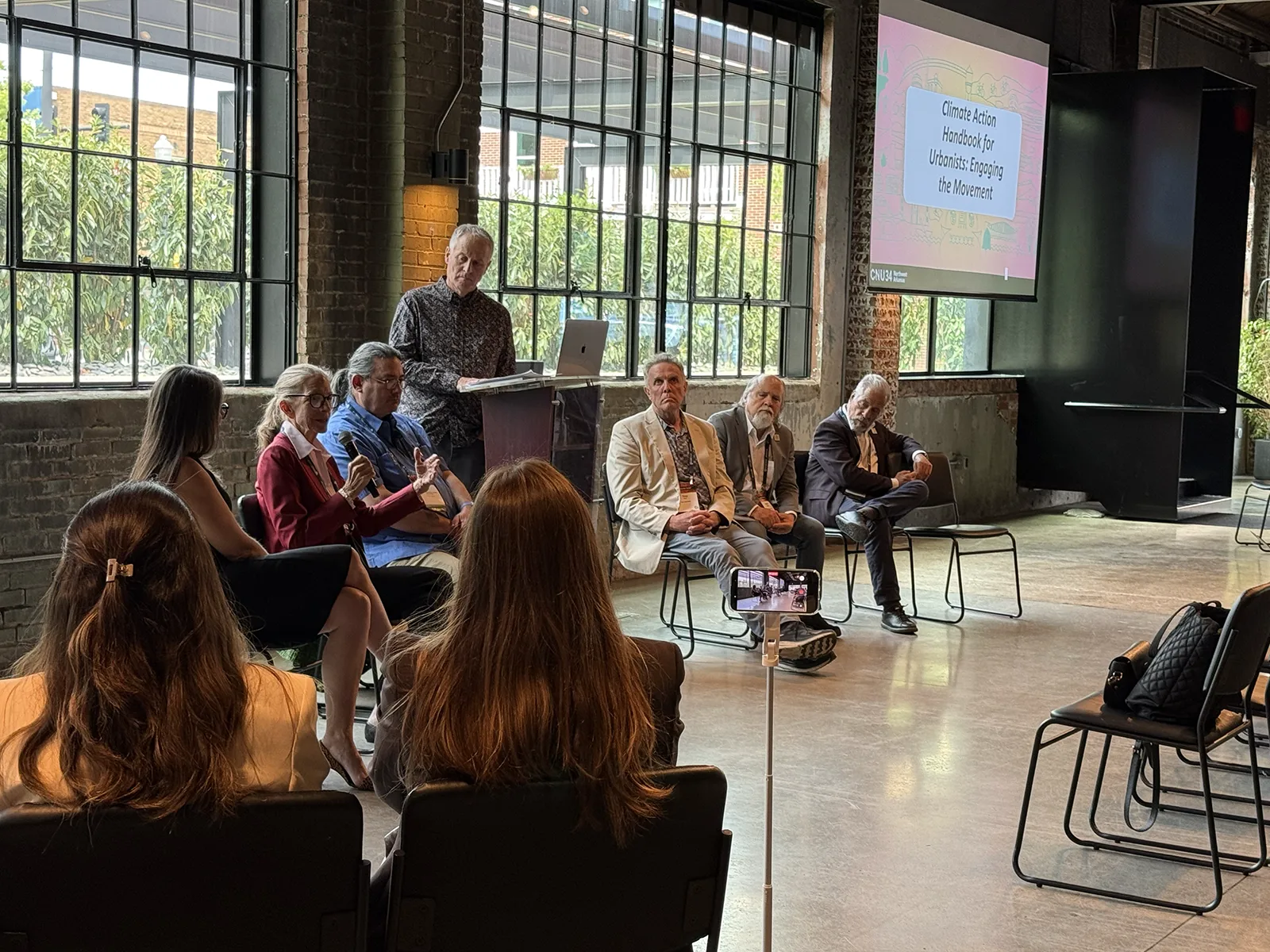 Presenter and panelist discussing Climate Action Handbook
